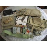 A selection of WWII military canvas bags, belts and other accessories to include a wooden handled