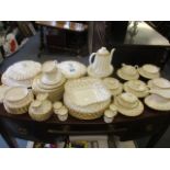 An extensive Spode gold coloured Fleur de Lys part dinner and coffee service, white background