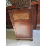 An Edwardian inlaid mahogany and cane fronted linen basket with cane-work back, hinged lid and cloth