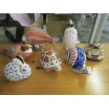 A collection of seven Royal Crown Derby animal paperweights, five with silver stoppers, to include a