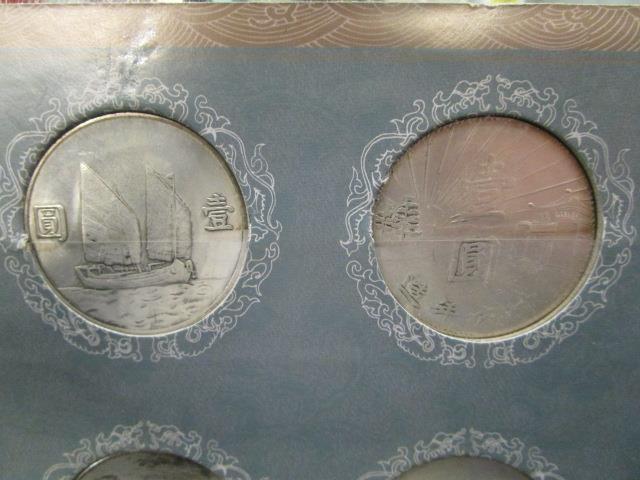 A collection of Chinese dollar coins mounted in two card displays - Image 7 of 8