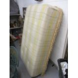 A modern ottoman upholstered in a Welsh blanket on castors, 16"h x 61 2/2"w