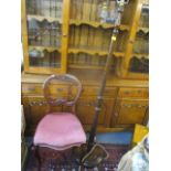 A Victorian mahogany balloon back dining chair, together with a standard lamp and an occasional