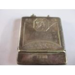 A silver plated matchbook case with a Grecian head decoration to the front