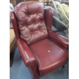 A late 20th century leather wing back chair in cherry red