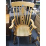 A beech Windsor splat back armchair on turned legs