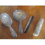 A four piece silver backed dressing table brush set, initialled with the letter 'H'