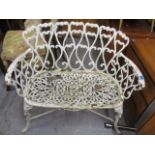 A weathered cast iron garden bench with scrolled ornament, on cabriole legs