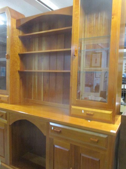 A Stewart Linford large cherry wood dresser having open shelves, flanked by glazed doors above two