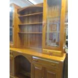 A Stewart Linford large cherry wood dresser having open shelves, flanked by glazed doors above two