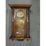 A Junghans walnut cased Vienna wall clock with pendulum and key