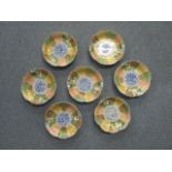 A group of seven 19th century old Japanese Imari petal-shaped dishes, the centre depicting a