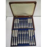 A Victorian silver plated twelve place setting canteen of dessert knives and forks with scroll,