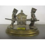 A brass inkwell in the form of two men carrying a Sedan chair