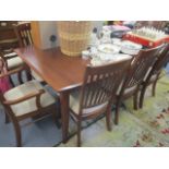 A modern cherry wood dining table with four extra leaves 30"h x 72 1/2"w and a set of eight matching