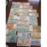 A mixed lot of banknotes from around the world to include Polish, Japan, Malta, Australia,