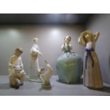 A group of five Lladro and Nao porcelain figurines to include one of a girl holding a goose in her