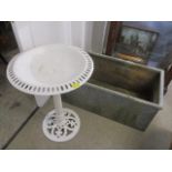 A galvanized trough 16"h x 37"w, together with a painted cast iron table 29"h x 20"w