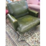 A Vintage 1960s/70s green leather upholstered swivel armchair
