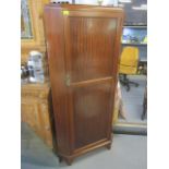 A mid 20th century mahogany corner cabinet with a full eight panelled door