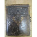 A Victorian leather bound photograph album containing various family member photographs