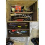 A wooden tool box containing vintage tools including an Elora drop forged 18" monkey wrench