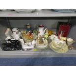 Three shelves of miscellaneous china, ornaments and glassware to include two claret jugs, part tea