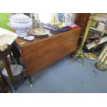 A Victorian mahogany drop leaf table on turned legs