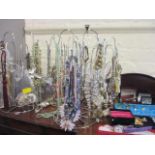A selection of costume jewellery to include necklaces, brooches, watches, jewellery boxes and stands