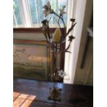 A gilt metal candle holder with porcelain flower heads, 30" h
