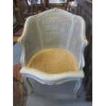 A French grey painted, cane seated armchair on cabriole legs