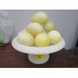 A mid 20th century Italian carved alabaster fruit bowl on a pedestal base having a display of