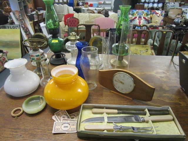 A selection of oil lamps, shades and accessories, along with a Tempora mantel clock and a boxed