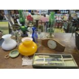 A selection of oil lamps, shades and accessories, along with a Tempora mantel clock and a boxed