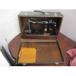 A Singer manual sewing machine in a carrying case