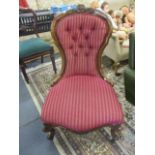 A Victorian salon chair with burgundy striped upholstery on a carved mahogany frame