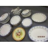 A Royal Doulton 26-piece dinner service and two floral decorated plates