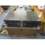 A Victorian stained pine trunk with iron carrying handles and a black painted wooden chest