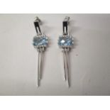 A pair of 18ct white gold earrings set with a rectangular topaz and two bands of diamonds, 8.8g