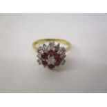 An 18ct gold, diamond and ruby cluster ring set with thirteen diamonds and six rubies, stamped