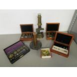 An early 20th century brass microscope, a Griffin and Tatlock instrument, and four cases of