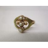 A gold coloured metal ring set with a row of three pearls, flanked by two balls, with patterned,