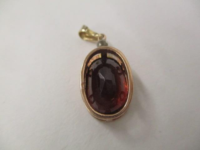 A 9ct gold pendant set with a diamond and a brown coloured stone, along with a cameo brooch with a - Image 3 of 4