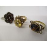 Two 9ct gold rings, one set with a tigers eye cabochon and the other a citreen, 10.1g and a white