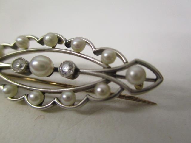 A gold and white coloured metal brooch of oval lobed form, set with thirteen pearls and two diamonds - Image 2 of 3