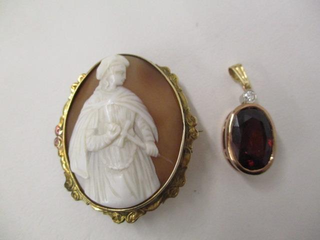 A 9ct gold pendant set with a diamond and a brown coloured stone, along with a cameo brooch with a