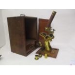 A Baker High Holborn, London - a gilt brass microscope and lenses to include one in a canister,