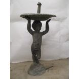 A mid 20th century lead fountain with a bowl, elevated by a boy on a rocky base, 33"h x 15"w