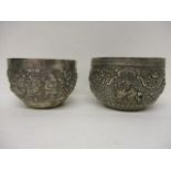 Two late 19th/early 20th century Indian silver bowls, one decorated with embossed and chased