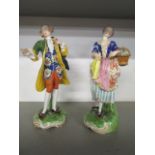 A pair of late 19th century porcelain figures of a girl with a basket of flowers, and a man offering